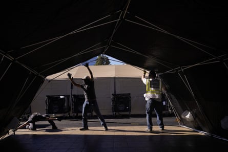 Volunteers in southern California help build a mobile field hospital. The state’s overwhelmed hospitals are setting up makeshift extra beds for coronavirus patients.