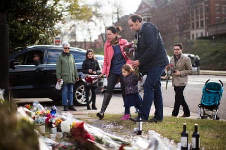 Visitors leave flowers at a memorial outside the French embassy in Washington DC in tribute to the victims of the Paris attack