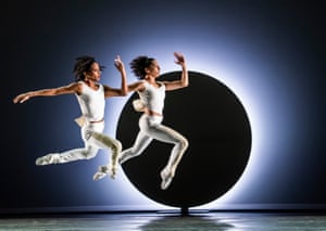Two dancers stride while leaping