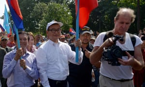 Australian film-maker James Ricketson (right) filming as opposition leaders Sam Rainsy (centre) and Kem Sokha (left) attend a demonstration in Phnom Penh in 2013.