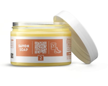 A jar of Savon soap – a Solid glycerine soap for shoes and leather equipment. The jar is glass and the white lid is off and resting against the right side of the jar.