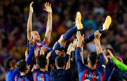 Sergio Busquets is thrown in the air by his teammates after his final game for Barcelona.