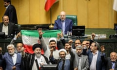 Iranian lawmakers chant slogans at an open session of the parliament in Tehran on Sunday