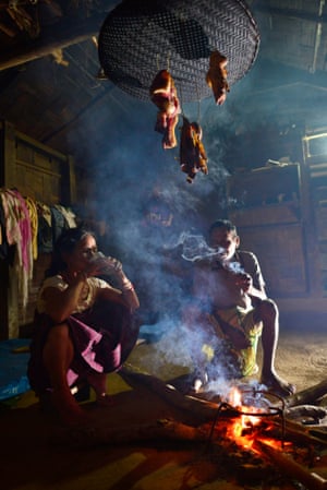 Assam state, India Members of the Tiwa tribe smoke dried pork
