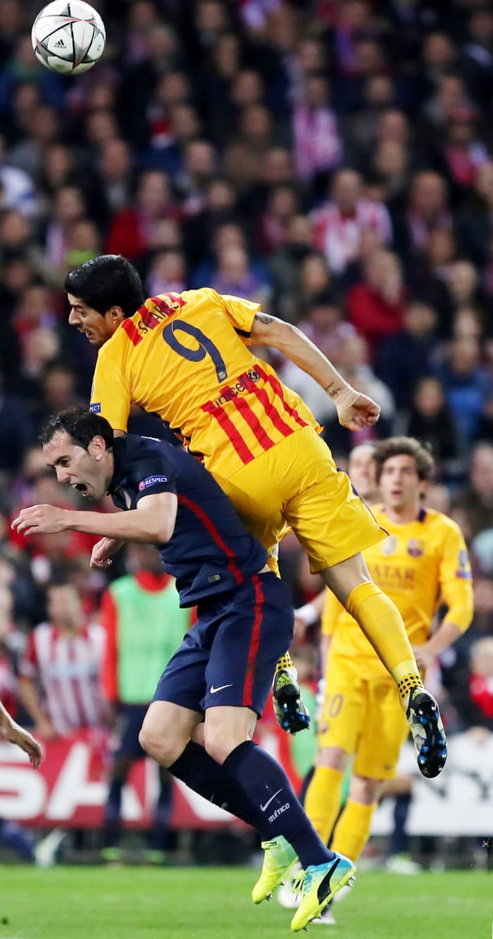 Atletico Madrid’s Diego Godin (bottom) vies with Barcelona’s Luis Suarez
