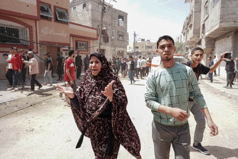 Palestinians react to an Israeli strike in the central Gaza Strip on 22 April.