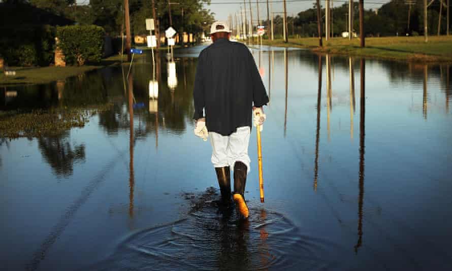 Paul Morris checks on neighbours’ homes in a flooded district of Orange as Texas slowly moves toward recovery from the devastation of Hurricane Harvey.