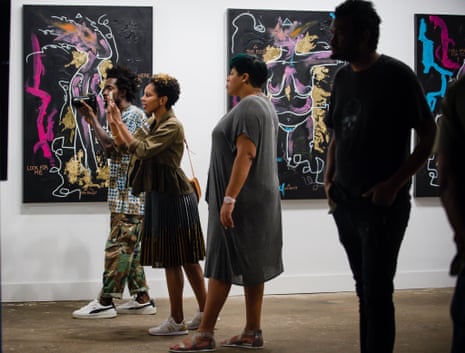 Visitors attend the opening of artist Miya Bailey’s solo exhibition, #LiveForeverMiya, at the Notch8 Gallery.