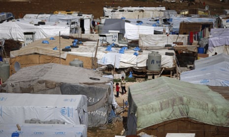 Syrian children stand outside tents at a refugee camp in the town of Hosh Hareem, in east Lebanon’s Bekaa Valley