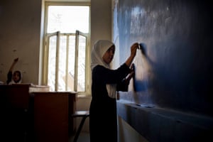 A pupil writes on a blackboard at the Malalai high school for girls, many of whom are reportedly setting their sights on higher education.
