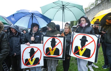 Protesters holding signs while blocking Garvaghy Road