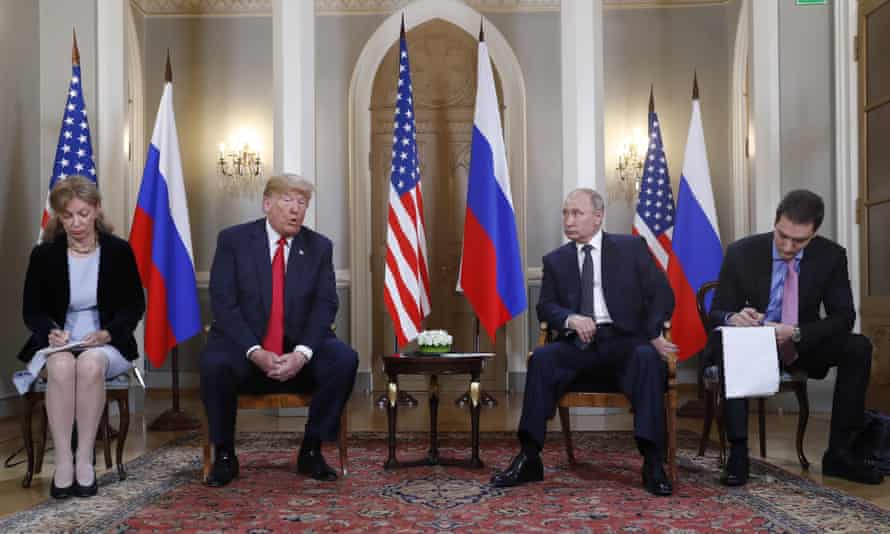 Interpreters take notes during Donald Trump's meeting with Vladimir Putin in 2018.