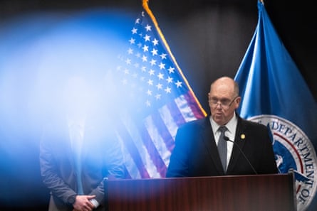 a man in a suit speaks into a microphone