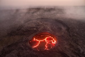 This aerial image offers a rare glimpse inside of Erta Ale, which means ‘Smoking Mountain’ in the local Afar language. Erta Ale volcano, Danakil, Afar, Ethiopia