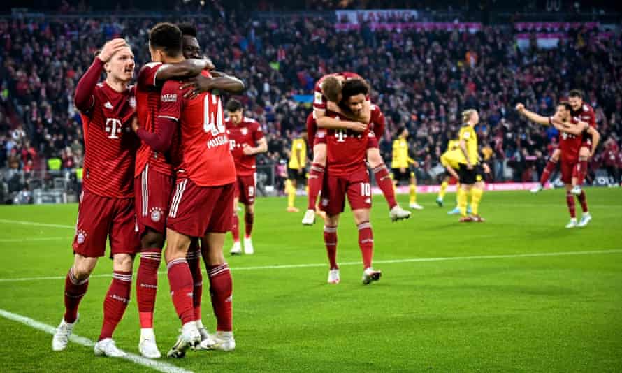 Bayern's Jamal Musiala (third left) celebrates with his teammates after scoring their third goal.