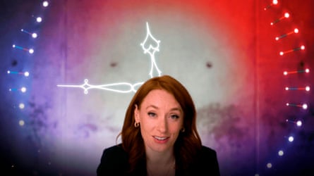 A woman sits in front of a clock projection