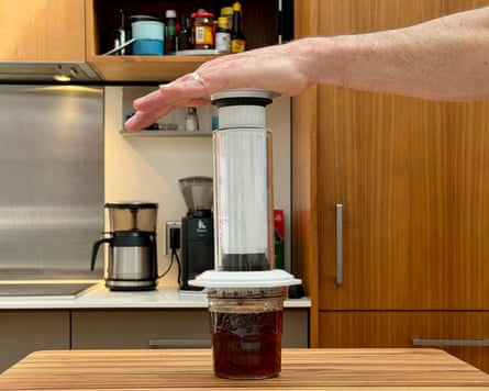 A person making coffee with an aeropress premium