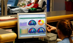 Nurse managers uses a healthcare app in a surgery day care ward.