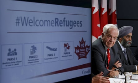 John McCallum, left, announces the refugee resettlement program alongside the defence minister, Harjit Sajjan, in Ottawa on 24 November 2015.