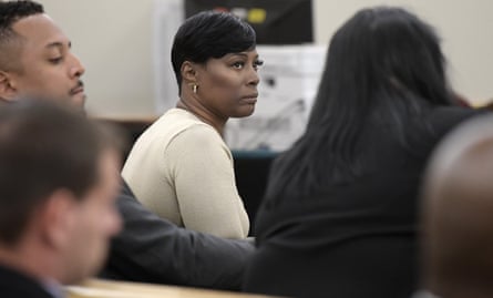 A middle-aged woman looks to the side.