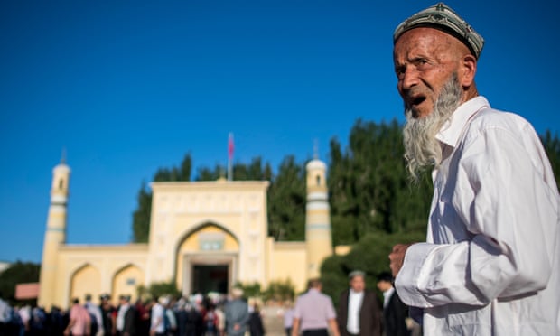 Muslim man stands in front of mosque in Xinjiang