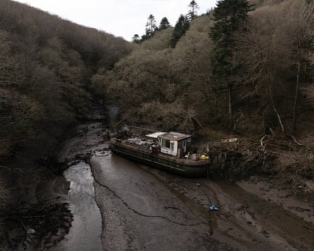 A large abandoned boat lies on the Ponsontuel Creek near Gweek.