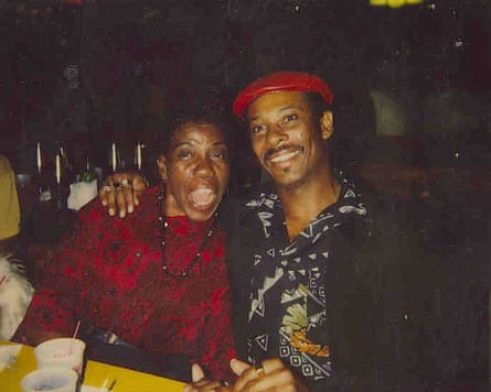 man smiles with arm around woman