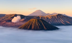 Volcano and other mountains rising from mist