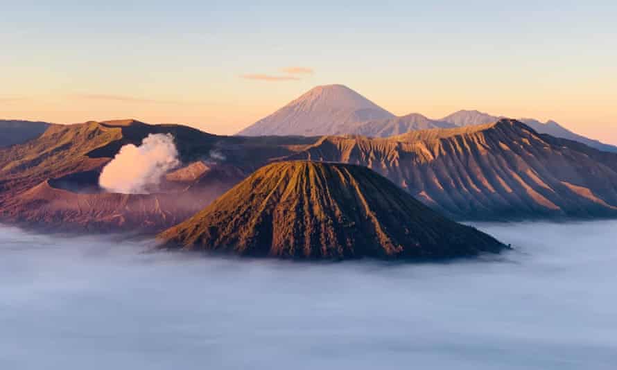 Volcano and other mountains rising from mist