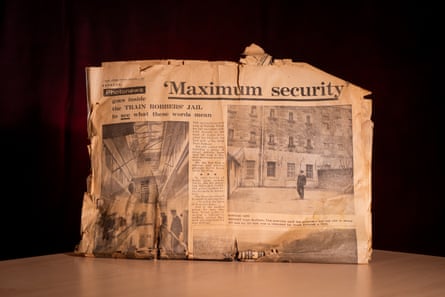 Yellowed newspaper pages with the headline ‘Maximum security’