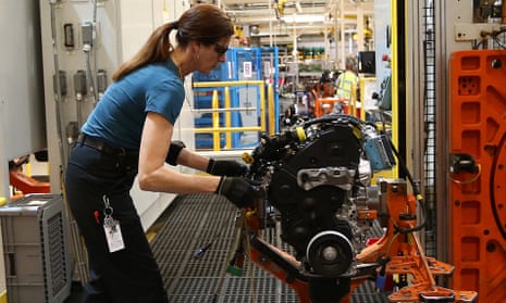 An employee at work on an engine production line at Ford’s factory in Dagenham, London.