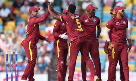 Matthew Forde of West Indies celebrates with teammates after getting the wicket of Phil Salt.