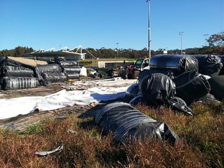 The rolls of old turf sitting by the side of the oval.