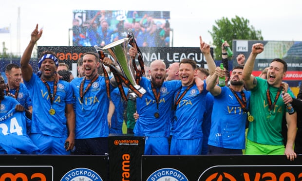 Stockport County players lift the Vanarama National League trophy.