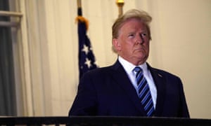 Donald Trump poses on the White House balcony after his return from Walter Reed medical center.