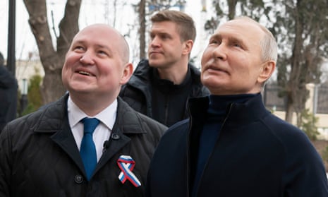 Mikhail Razvozhayev, left, with Vladimir Putin in Sevastopol in March