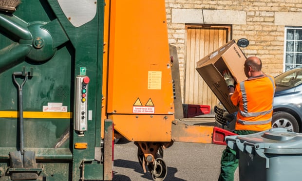A council workman taking cardboard waste to a refuse lorry