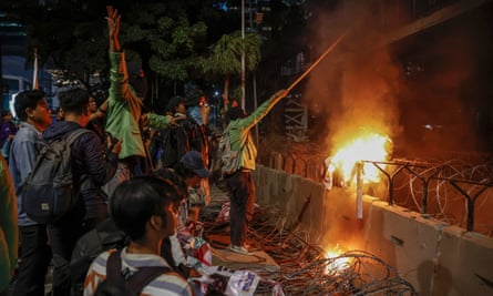 Students burn banners during a protest against the constitutional court’s decision on the presidential candidates age limit that paved the way for President Joko Widodo’s son Gibran Rakabuming Raka to enter the race to become vice-president.
