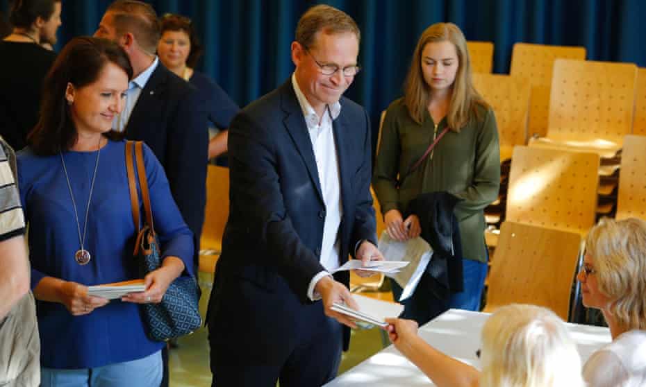 Berlin’s mayor Michael Mueller receives his ballot papers at a polling station in Berlin.