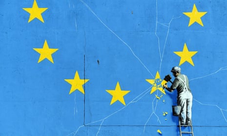Detail of a Banksy mural showing a man chipping one of the stars off the EU flag