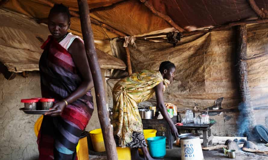 Elizabeth Nyalony, left, a mother of three young children, fled Leer for Nyal, where she has set up a stall selling coffee and tea.