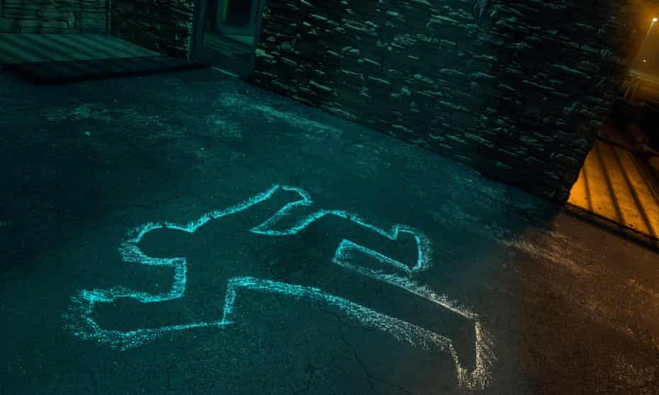 chalk outline of body of victim on pavement.