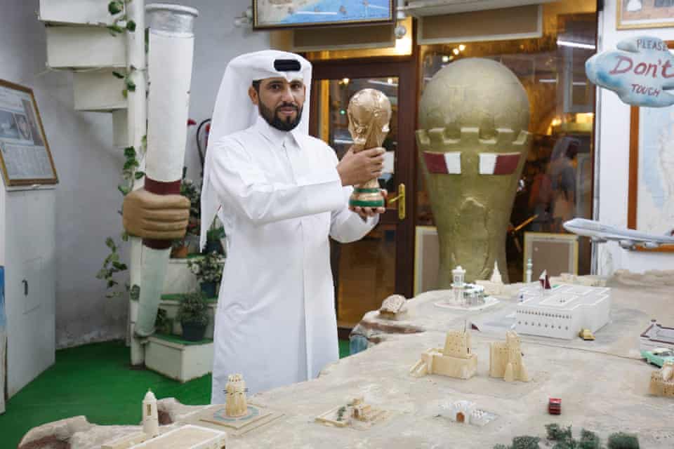 Qatar 2022 World Cup preparations: a tourist merchandise seller holding a replica World Cup in the Souq Waqif market