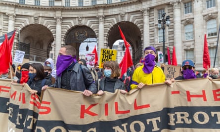 Protesters against the policing bill hold large Kill the Bill banner, standing in front of Admiralty Arch, central London in May 2021.