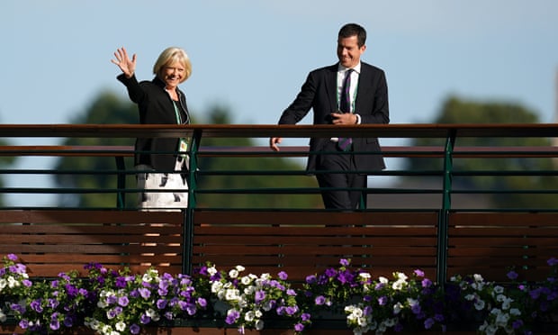 Sue Barker, crosses the players’ bridge with Tim Henman