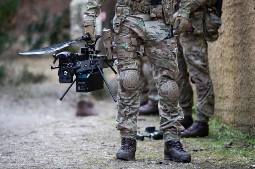 A British marine holds a Ghost drone during an exercise.
