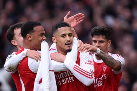William Saliba of Arsenal celebrates with teammates after scoring.