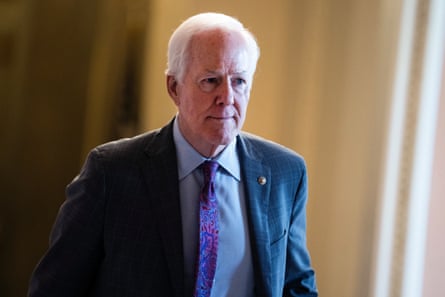 John Cornyn walks in a corridor