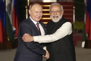 Russian President Vladimir Putin, left, and Indian Prime Minister Narendra Modi greet each other before meeting in New Delhi in 2021