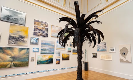 A gallery view of the Summer Exhibition 2022, featuring Douglas White’s charred palm made out of blown-out tyres.